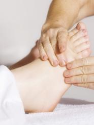 patient foot with physician massaging it